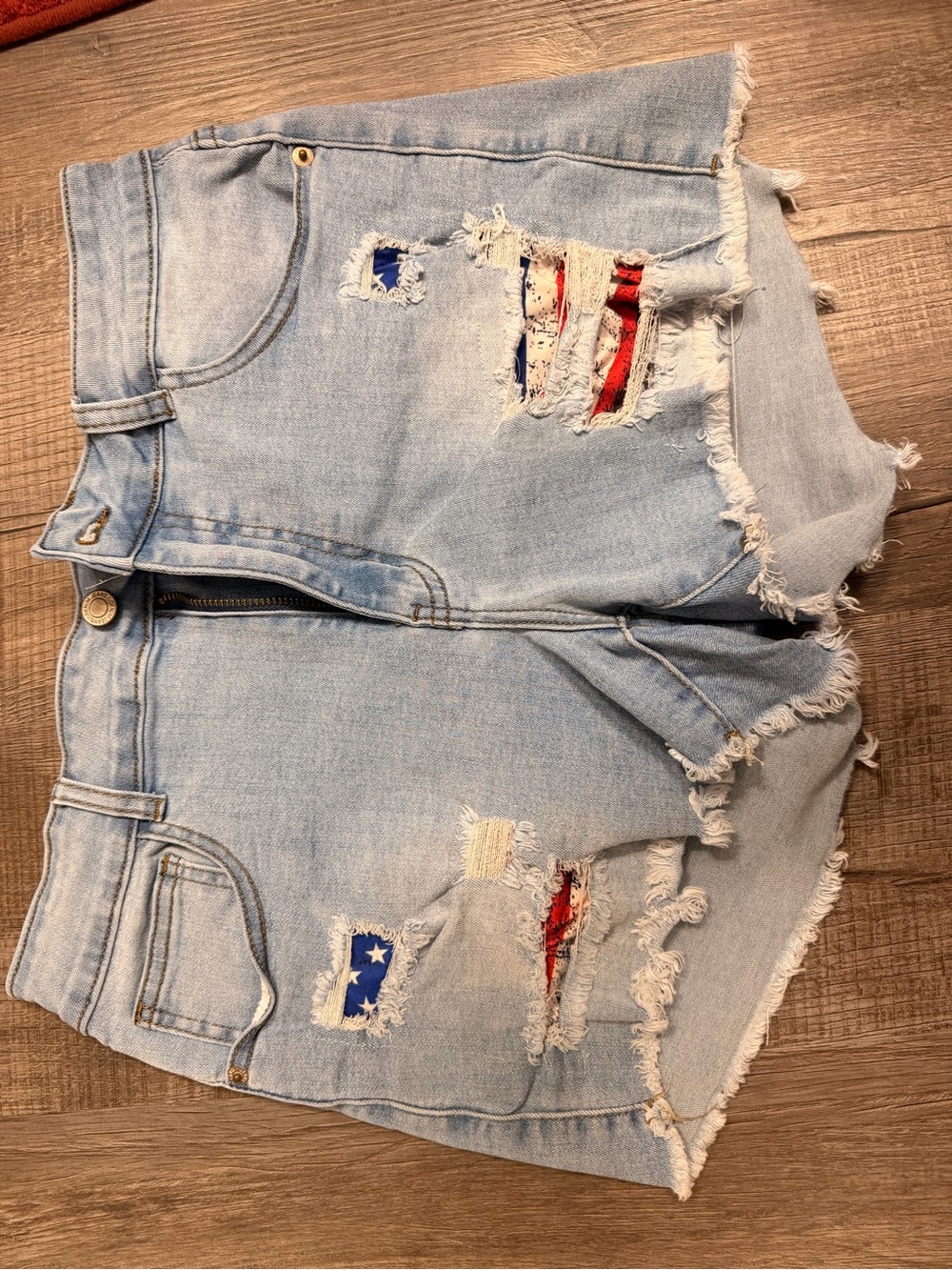 Light Blue Distressed Denim Shorts with Flag behind holes